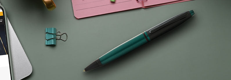 Calais Ballpoint Pen in Matte Green and Black Lacquer finish resting on a desk.